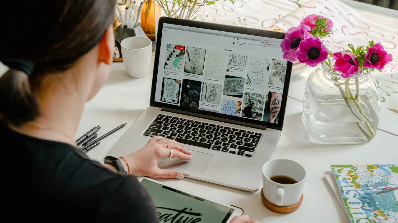 Photo of a woman on her Apple laptop.