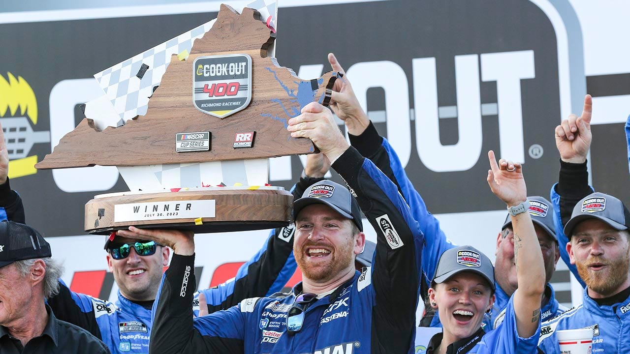 Chris Buescher holds the cookout trophy