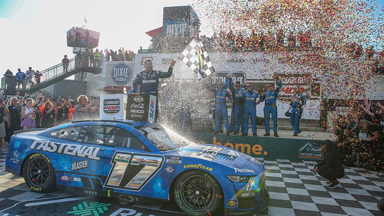 Chris Buescher holds the checkered flag