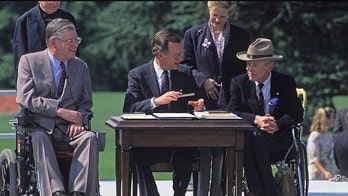 On this day in history, July 26, 1990, President George H.W. Bush signs Americans with Disabilities Act