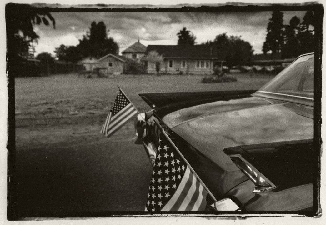 Car decorated with American flags