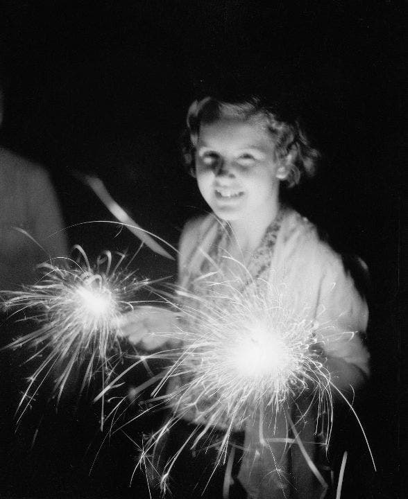 Girl holds 4th of July sparkler