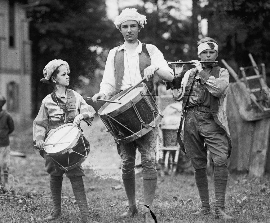 Boy marching band plays on 4th of July