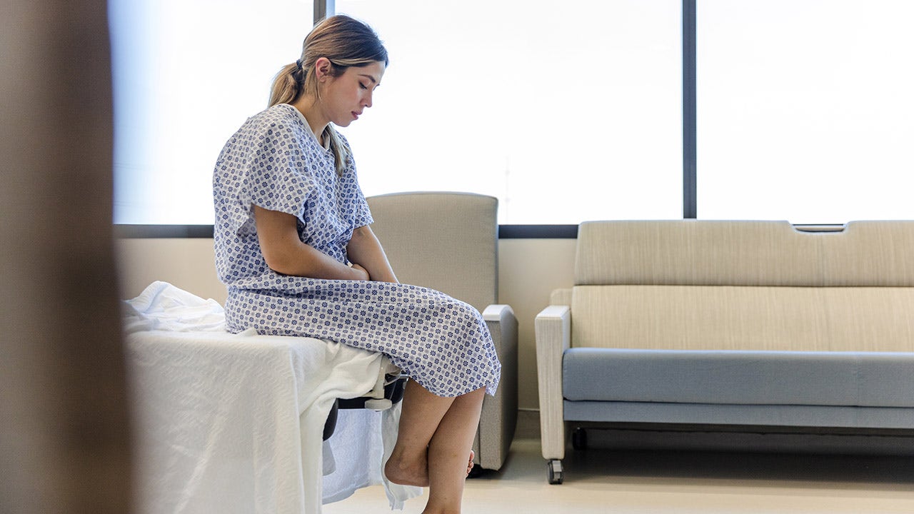 woman sitting on hospital bed